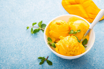 Mango ice cream, sorbet in a plate on a concrete background