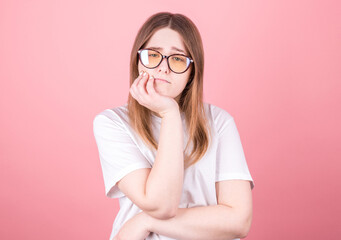  pretty girl in black glasses touching her face and bending over, peeking out from under her eyes,...