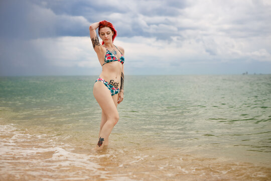 red haired girl rest on the sea shore