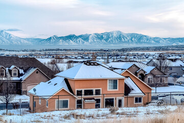 Family houses in a tranquil neighborhood with view of snowy mountain in winter