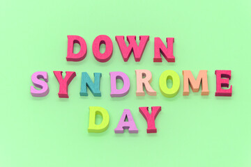 World down syndrome day - inscription laid out of wooden letters on light green background. Down syndrome awareness concept. Banner, illustration, poster. 