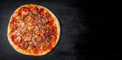  Italian pizza with sausage and onion rings on black background, top view, banner
