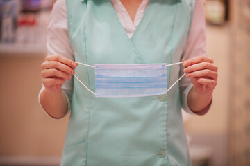 Nurse Holding a surgical mask in her hands