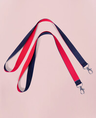 Lanyards red and black for events and business with Metal Lobster Clip. On a pink background. Lanyards have two different colors - Red and Black