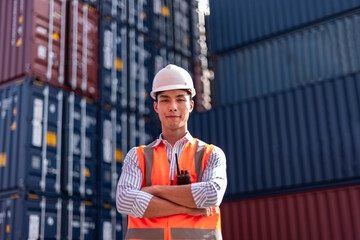 Asian logistics control worker professional wear safety helmets and protect suite working in shipping containerin commercial transport background.