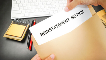Reinstatement order (Reinstatement notice) letter in the envelope at the office desk. Business...