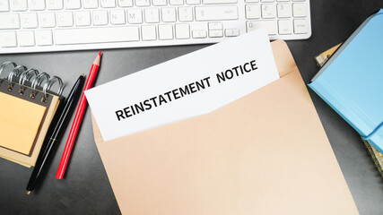 Reinstatement order (Reinstatement notice) letter in the envelope at the office desk. Business employment concept.