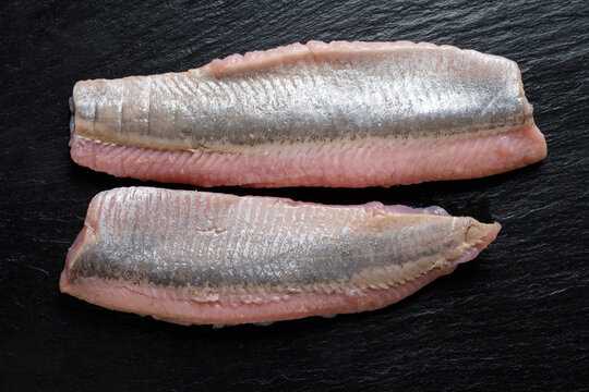 Maties herring fillets on a dark background top view 