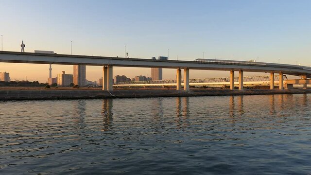 Evening sky and highway seen from the water's edge