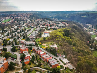 Fototapeta na wymiar Aerial view of row houses and old funcionalism architecture in background in residential area of Baba in Prague 6, Czech republic