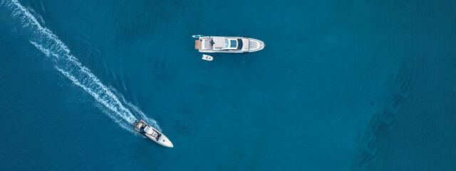 Aerial drone top down ultra wide photo of inflatable power rib boat making extreme manoeuvres in...