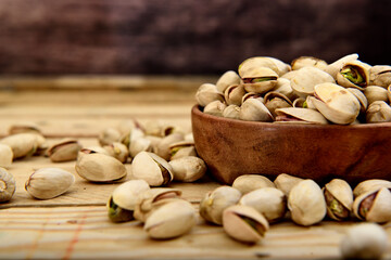 Organic pistachio in a wooden bowl on a table