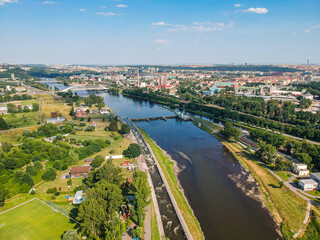 Fototapeta premium Moldau river in Troja area with architectonic bridge in background
