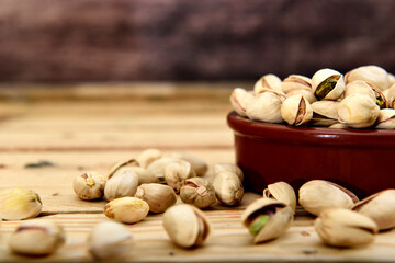 Organic pistachio in a ceramic bowl on a wooden table