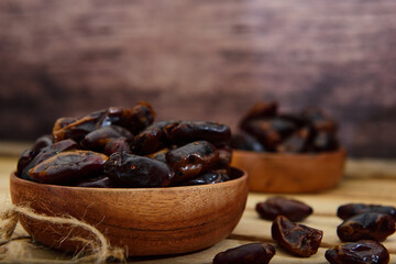 Dry Dates on a wooden bowl
