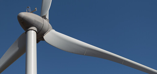 Detail of wind turbine against blue sky, clean energy generator wind turbine in wind farm © pavel1964