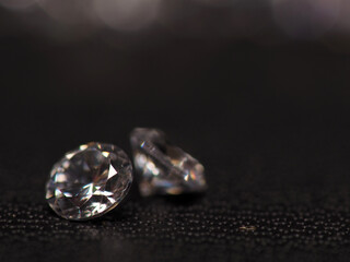 Close up shoot of group of sparkling diamonds, shoot on black leather as background