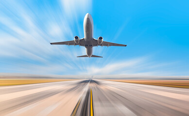 White Passenger plane fly up over take-off runway from airport 