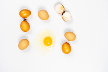 fresh eggs and one broken on white background