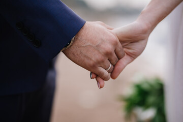 Bride and groom holding hands