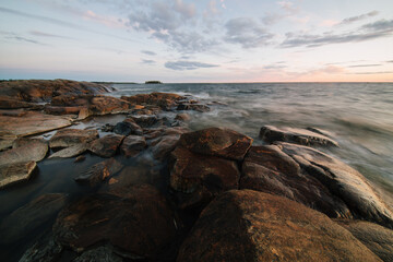 Scenic long exposure sunset over the rocky shore of Faboda, Finland
