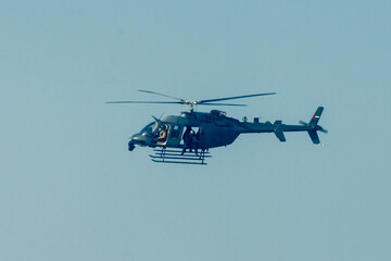 Military chopper in war flies through the sky. Military concept of power, force, strength, air raid.