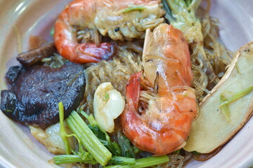 steamed shrimp with glass noodle and ginger on bowl dipping Thai spicy seafood sauce