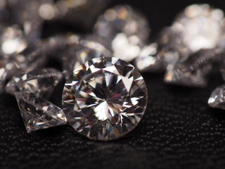 Close up shoot of group of sparkling diamonds, shoot on black leather as background