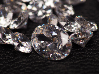 Close up shoot of group of sparkling diamonds, shoot on black leather as background