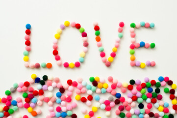 Handmade Valenine pom poms decoration. Written word 