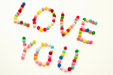 Handmade Valenine pom poms decoration. Written word 
