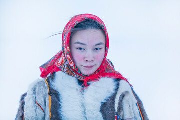 Young girl, in the national winter clothes of the northern inhabitants of the tundra, the Arctic...