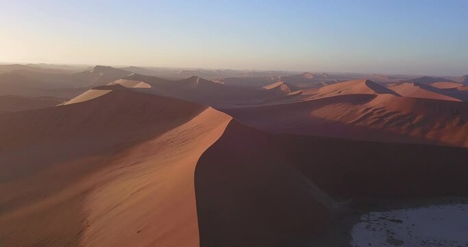 4K aerial drone footage of famous endless sand sea and Sossusvlei Namib Desert scenic red sand dunes on sunny morning in Namib-Naukluft Park in Namibia, southern Africa