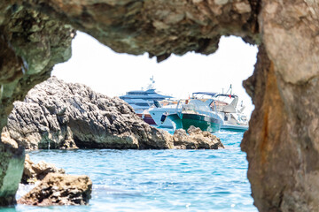 Fototapeta premium view of the yachts, near the siren cliffs on the coast of Capri