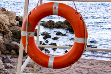 Lifebuoy hanging on the beach against background