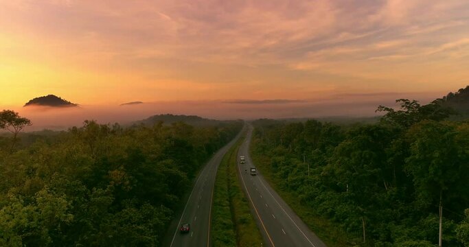 Wide Shot Car driving on Mountain road and Sunset countryside,  Establishing shot.