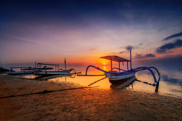 Balinese fishing boat took the Jukung. On the beach of Sanur in the sunrise with a great view of the sea
