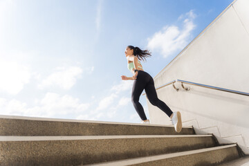 Beautiful asian woman outdoor exercise She un up the stairs