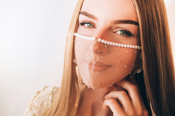 Bride look. Pandemic fashion. Princess style. Stay safe. Smiling woman in designer sheer pearl...