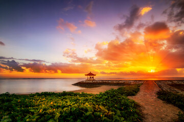 Balinese temple in the sea. On the beach of Sanur in the sunrise with a great view of the sea and the horizon. beautiful sky