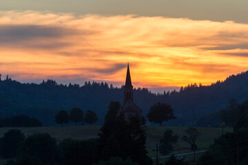 Sunset over the village Hofen in the Black Forest with the silhouette of the church