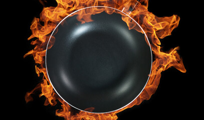 Empty wok pan, flames on background