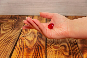 Woman's hand holds a heart. Heart Diseases, Heart Disease Center...