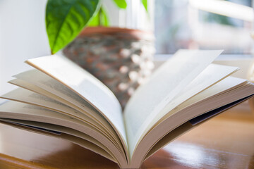 An open book by the window, reading a book. Students,school, teacher, learning