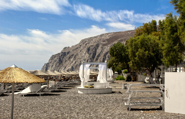 kamari beach at santorini island - mountains and blue sky 