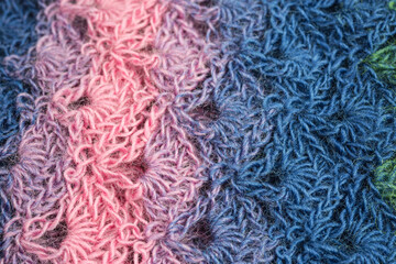 handmade multicolor crochet background in blue and pink with double crochet stitches