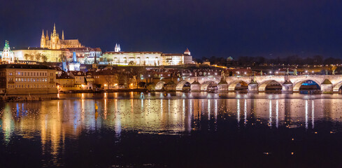 Fototapeta na wymiar Amazing panoramic view on Prague Castle, St Vitus Cathedral and Charles Bridge with reflection of lights in Vltava river. Old town, Czech Republic