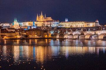 Amazing panoramic view on Prague Castle, St Vitus Cathedral and Charles Bridge with reflection of lights in Vltava river. Old town, Czech Republic