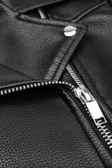 Black leather jacket close up. Textured leather, metal zipper.
