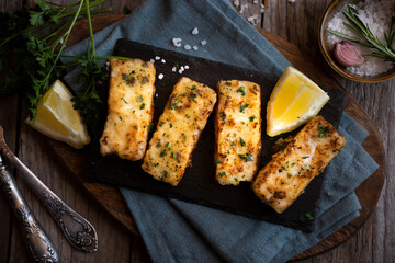 Cooked fish fillet with lemon and vegetables